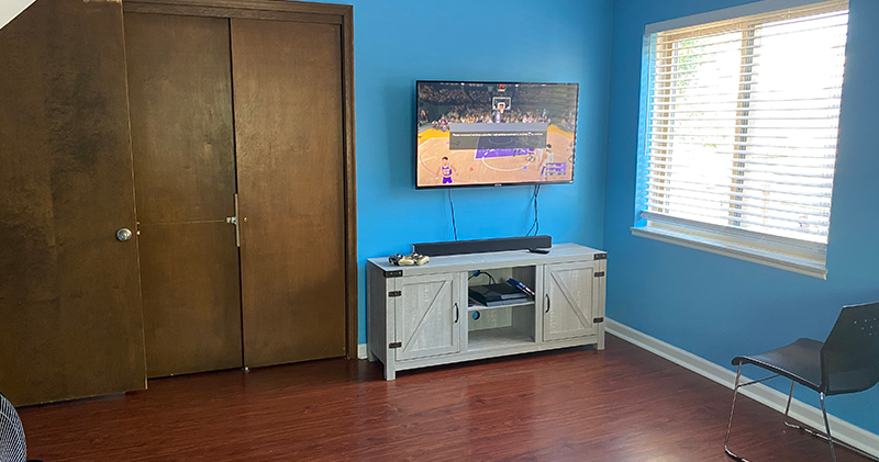 A tv mounted on the wall in a room.