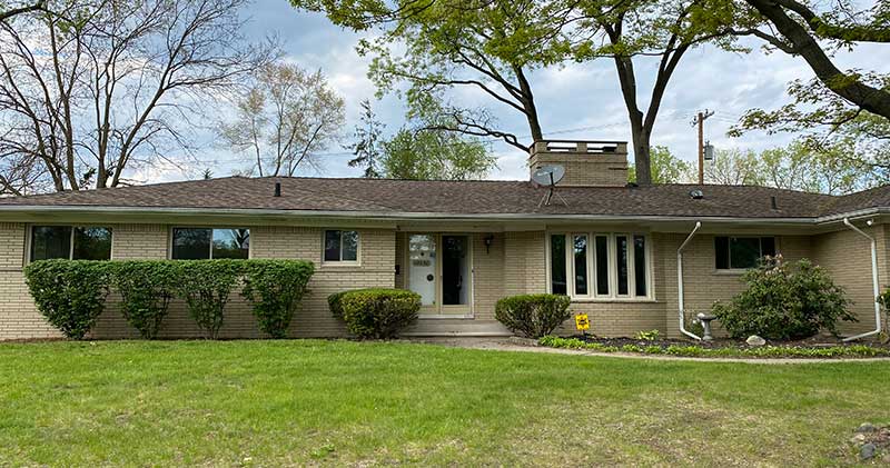 A house with a large lawn in front of it